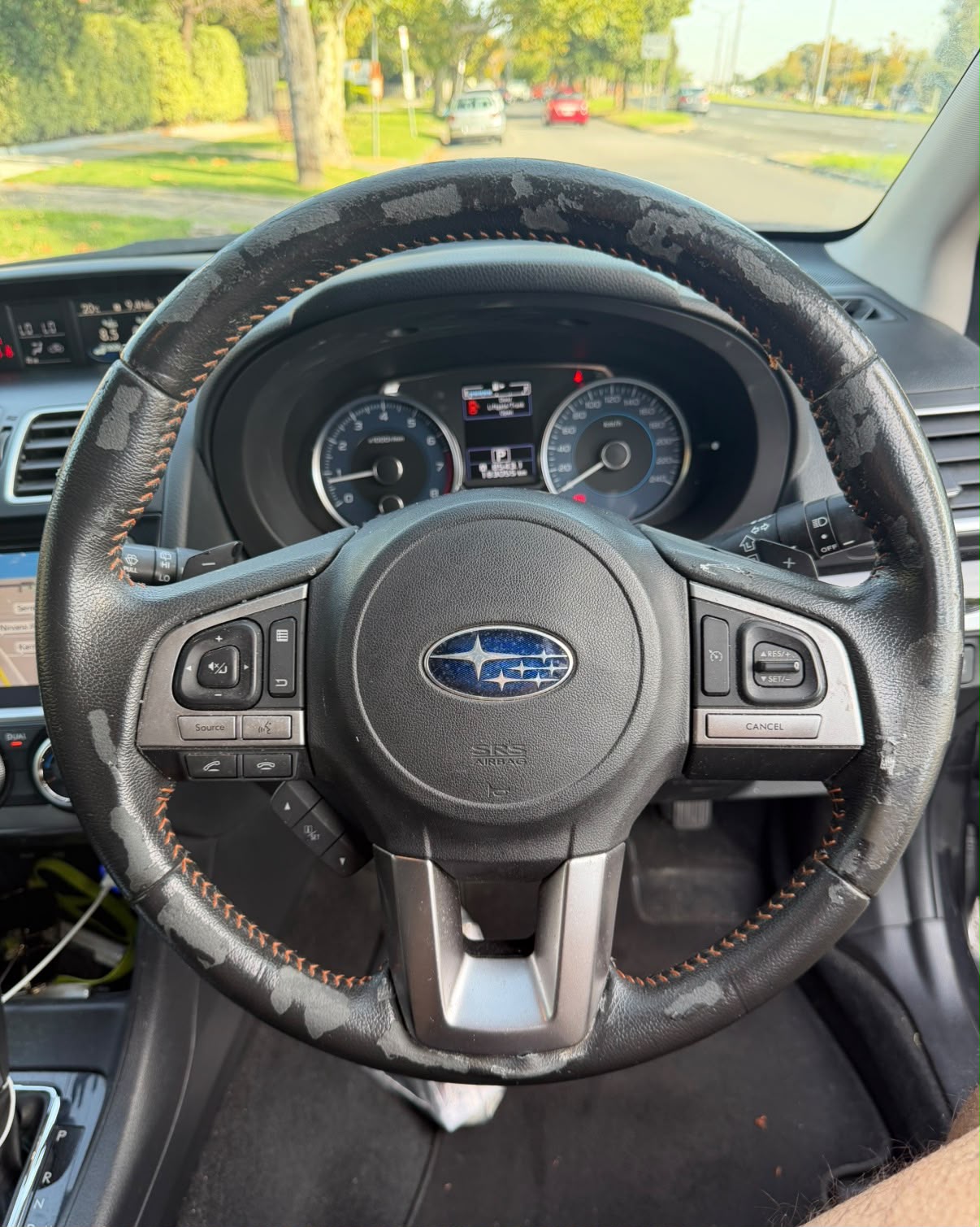 Cracked and worn steering wheel before wrap